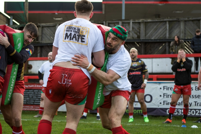 Keighley Cougar players warm up wearing Check In With Your Mate T-shirts.jpg